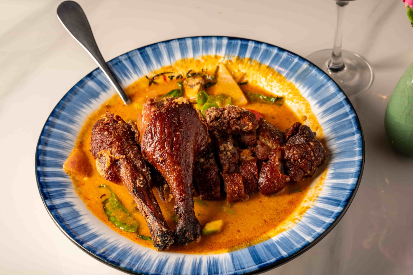Bangkok Duck half roast duck served in Thai red curry with basil and vegetables - East Moon Asian Bistro Centennial CO