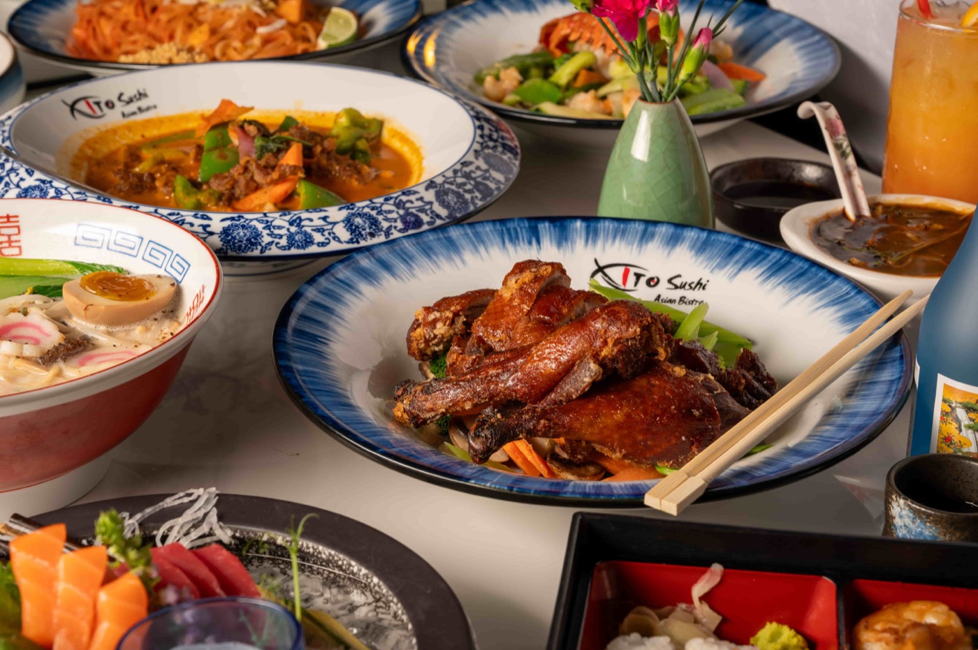 East Moon Asian Bistro dinner and take-out menu PDF - Thai curry, roast duck, ramen and sashimi on the table