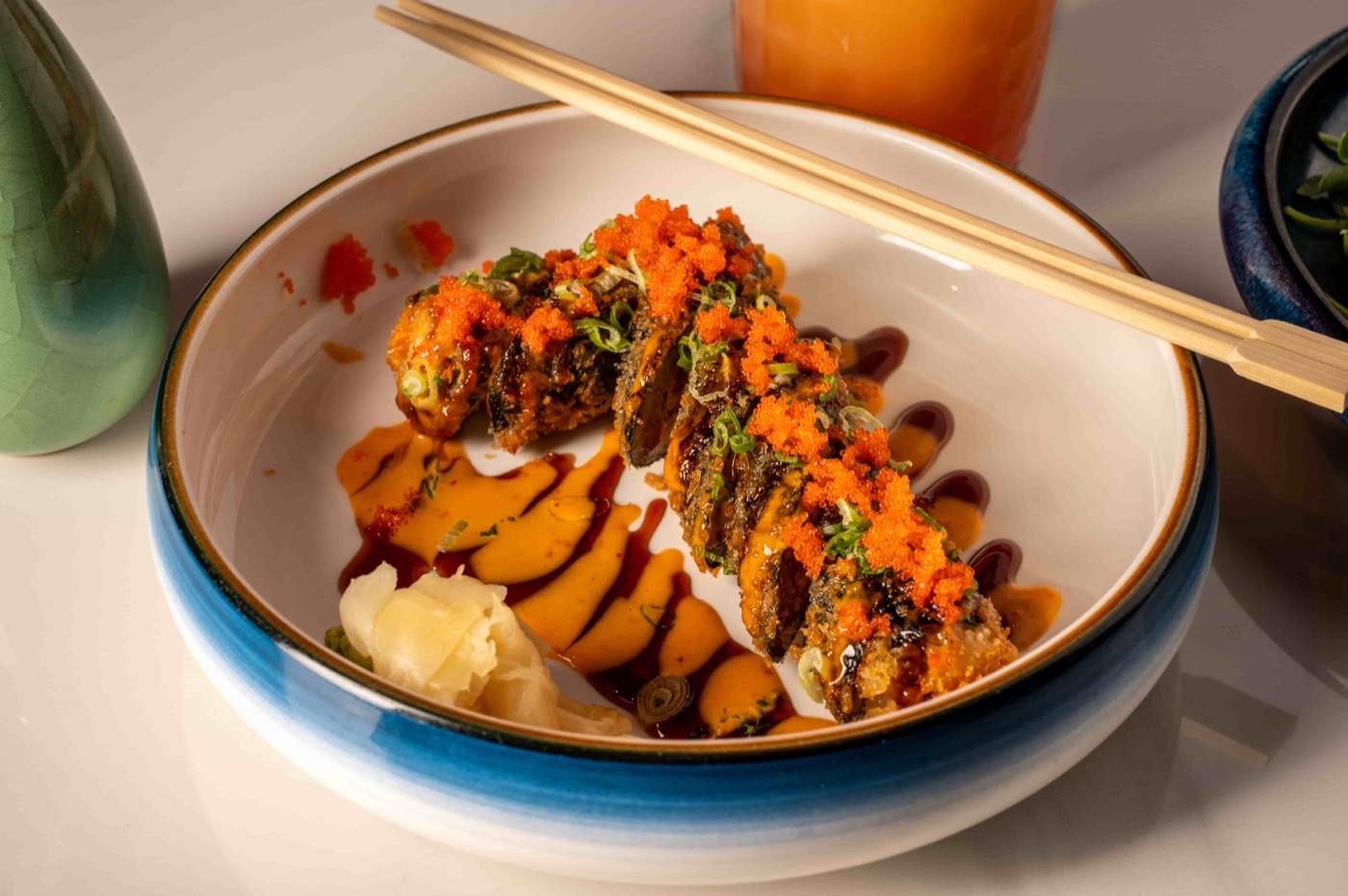 Lucky 7 Roll deep fried spicy tuna and avocado roll topped with flying fish roe and scallion - East Moon Centennial CO