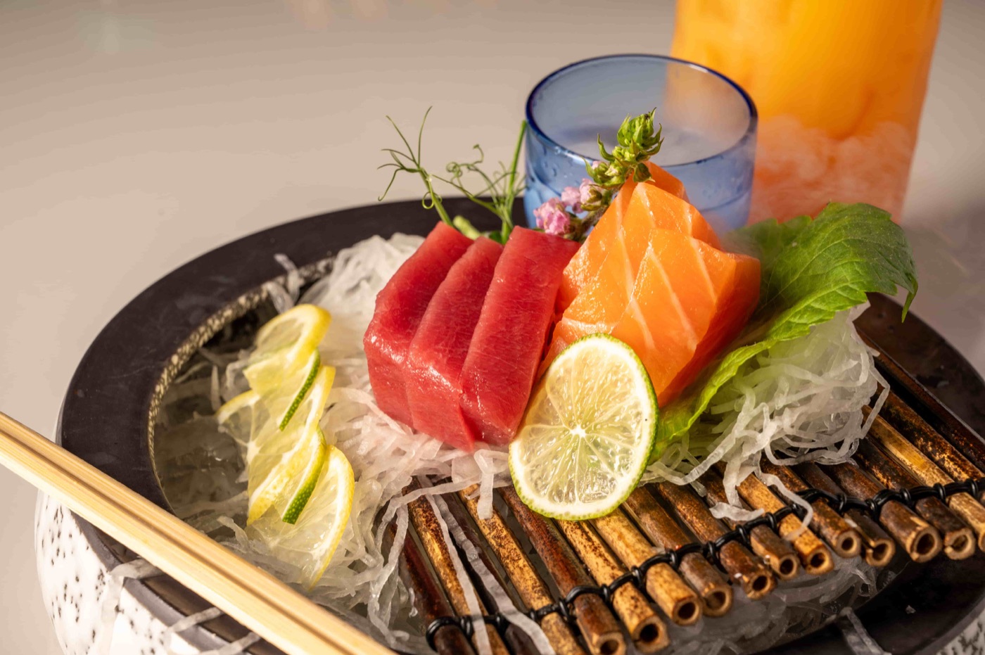 Fresh tuna and salmon sashimi hand cut over shaved daikon - East Moon Asian Bistro Centennial CO