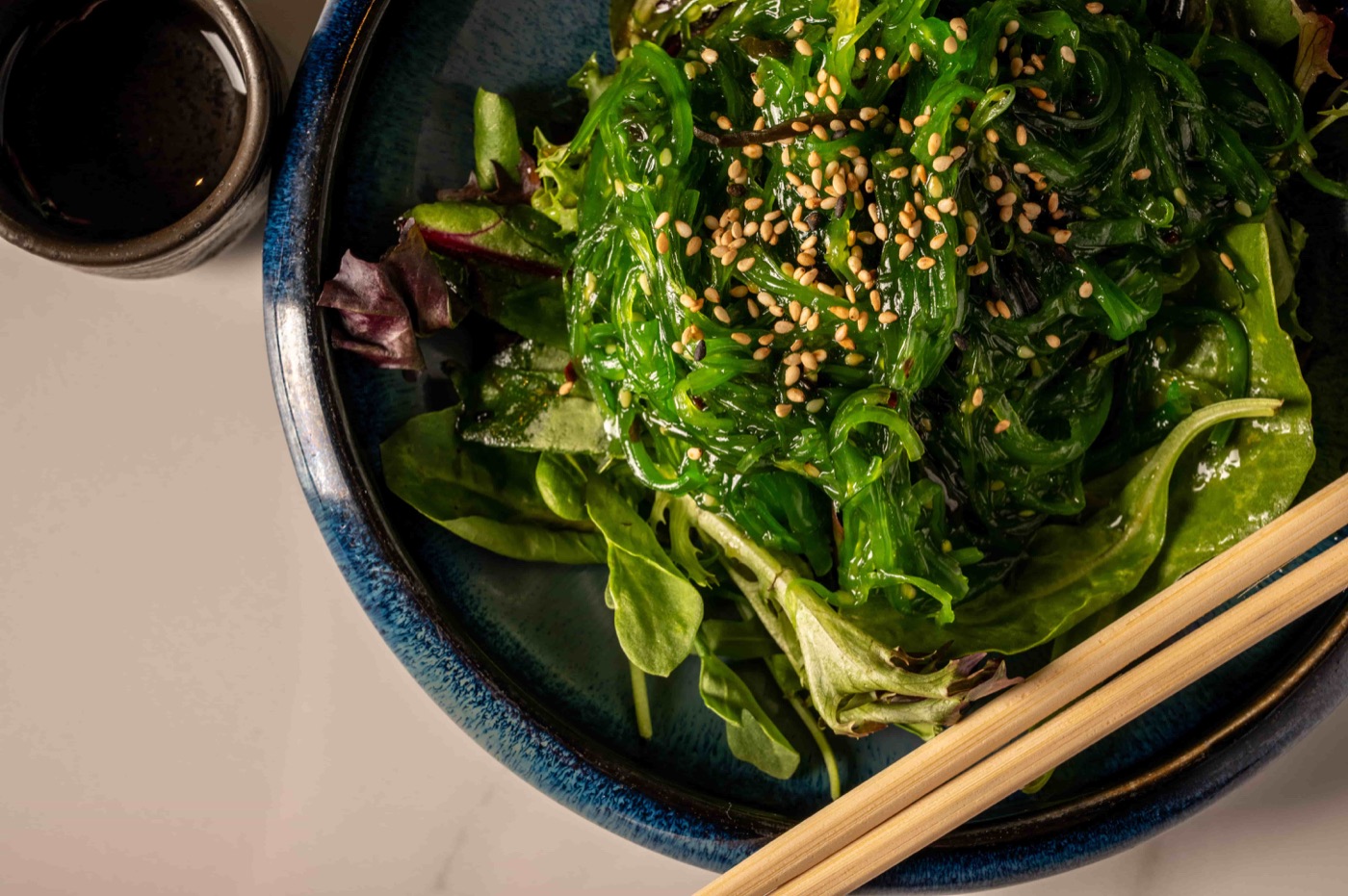 Seaweed salad with sesame seeds over mixed greens - East Moon Asian Bistro Centennial CO